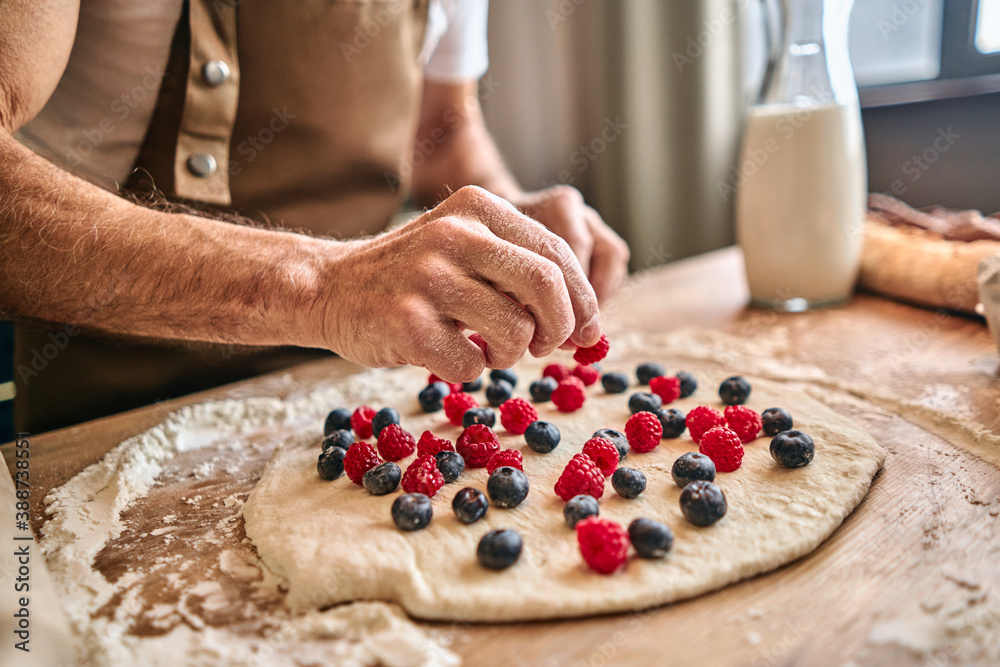 Chef preparing sweet pastries with fresh berries