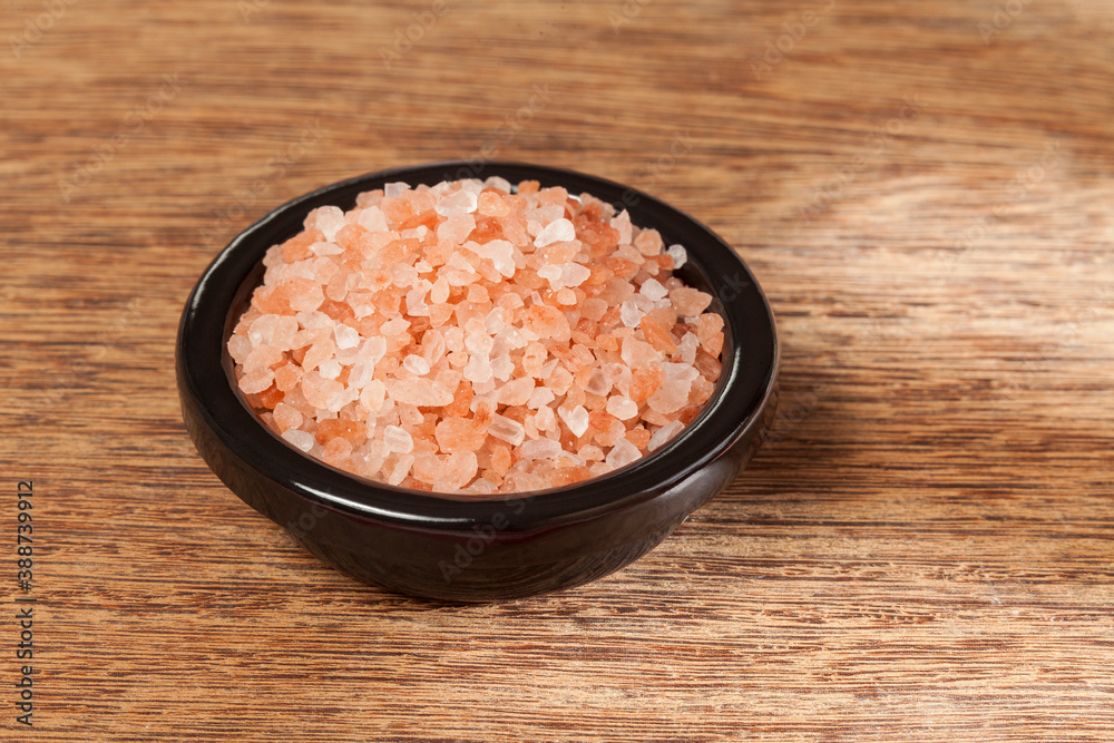 Salt; pink himalayan salt crystals, photo on wooden background. Salt; pink himalayan salt crystals, photo on wooden background.