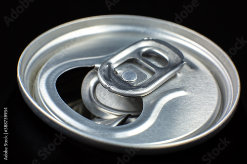 Can of fizzy drink close up on black background. Refreshing during summer heat. Vacations mood.