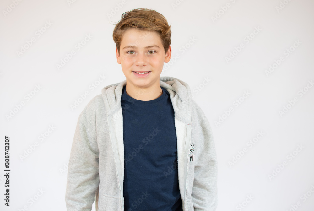 Photo of adorable young happy boy looking at camera over white background. Photo of adorable young happy boy looking at camera over white background.