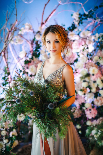 Wallpaper Mural The bride in a wedding silver dress poses against a blue wall with decor. Winter wedding concept. Selected focus. Blurred background Torontodigital.ca