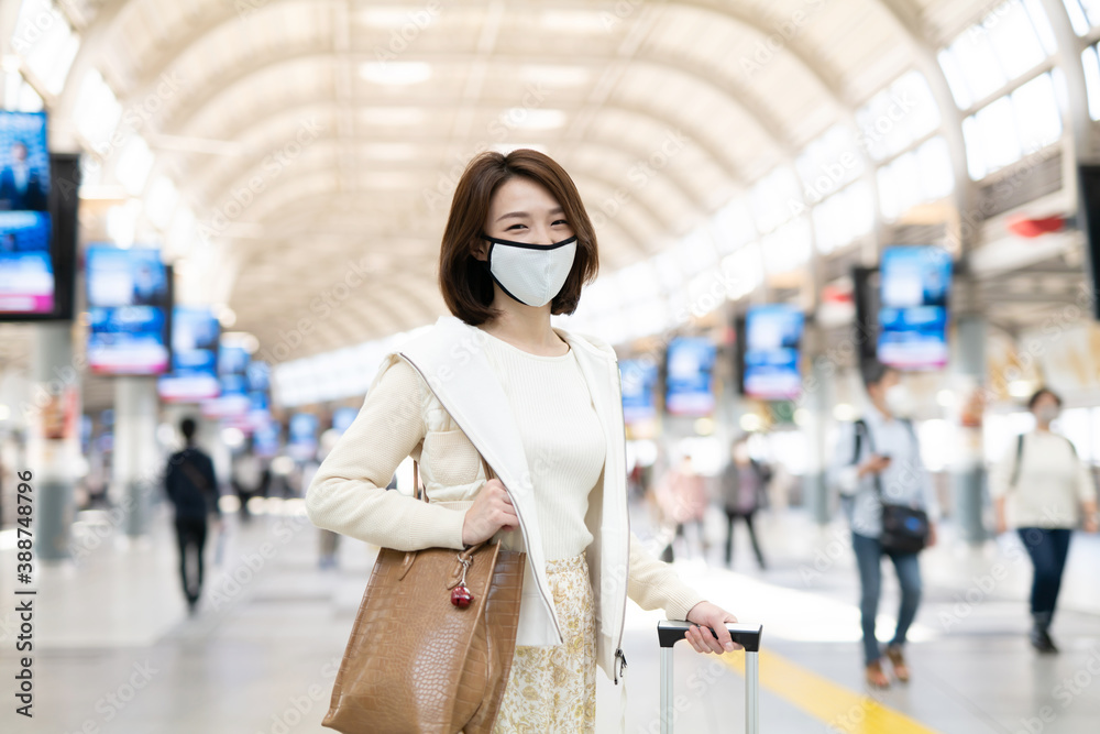 Young Asian woman wearing Surgical face mask at station.