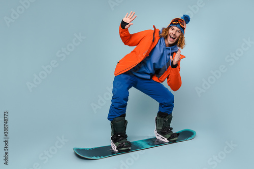 Young guy posing on a snowboard