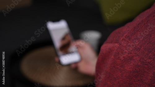 Close up shot of person swiping on tinder app on smartphone.Out of focus view.