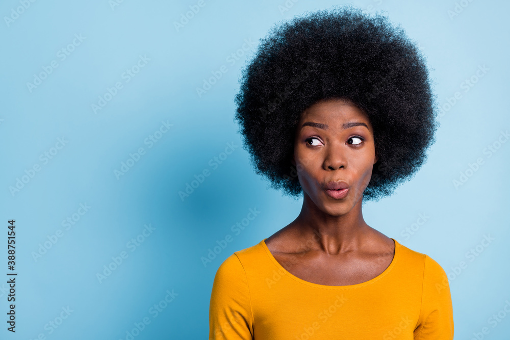 Photo of pretty shocked girl look side empty space funny face wear yellow shirt isolated blue color background Photo of pretty shocked girl look side empty space funny face wear yellow shirt isolated blue color background