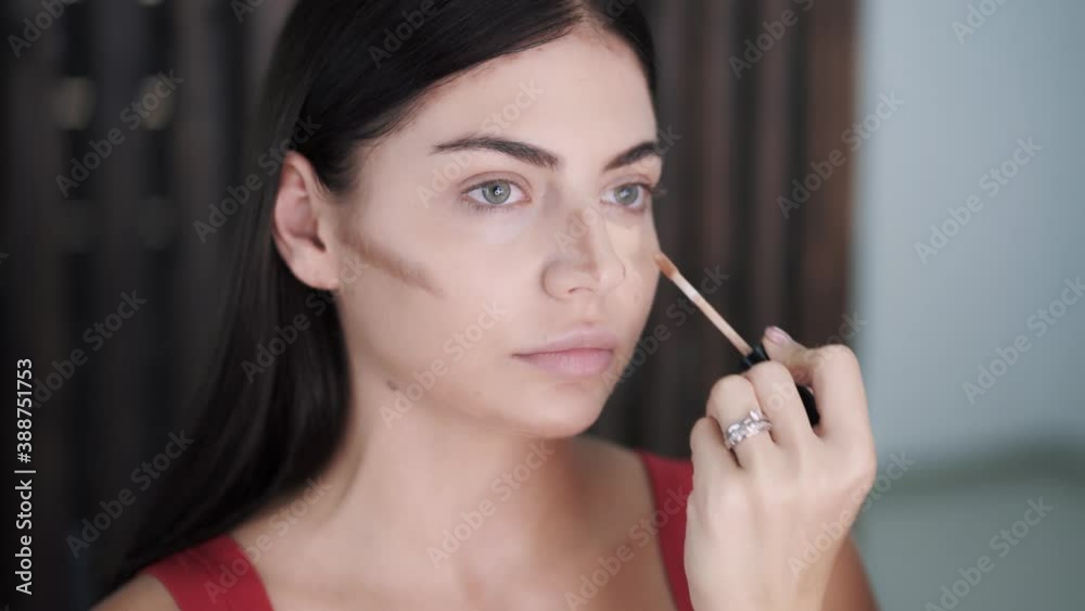 Hands of young makeup artist paint with brush the convex areas Hands of young makeup artist paint with brush the convex areas