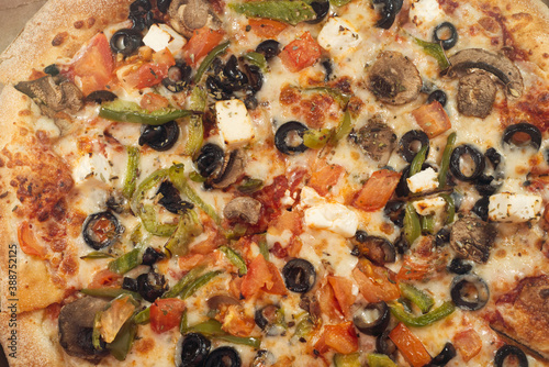 pizza with mushrooms, olive and other various products, close up