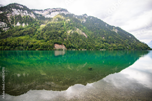 Clear blue summer day at lake Klontalersee. Glarnisch, mountain range reflecting in the water. Landscape in Switzerland. © Tereza