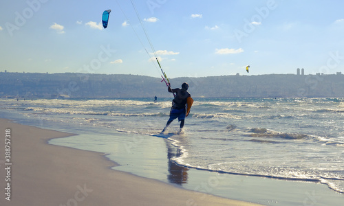 Man engaged kitesurfing on Sunny summer beach. Israel. Kiryat Yam. Haifa