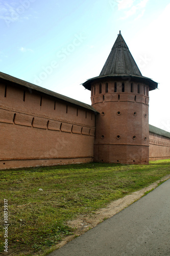 Red brick wall and tower of the monastery in Suzdal.