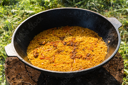 Bilde på lerret Freshly cooked pilaf in a big metal cauldron.