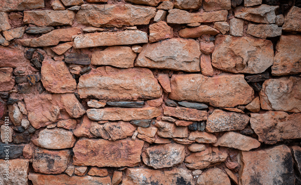 Background of red stones forming a wall with space for text Background of red stones forming a wall with space for text