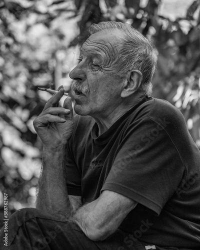 portrait of a smocking old man
