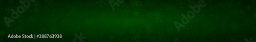 Christmas banner of snowflakes of different shapes, sizes and transparency on dark green background