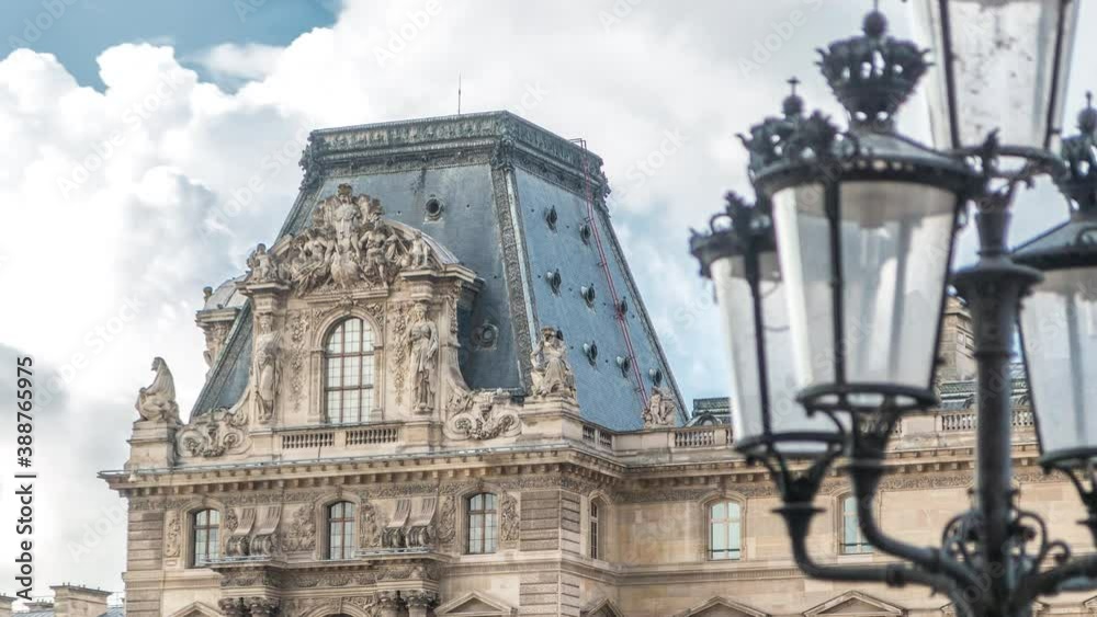 Side gallery entrance, streetlamp and architecture of the famous Louvre museum and gallery timelapse, Paris, France. Cloudy sky at summer day Side gallery entrance, streetlamp and architecture of the famous Louvre museum and gallery timelapse, Paris, France. Cloudy sky at summer day