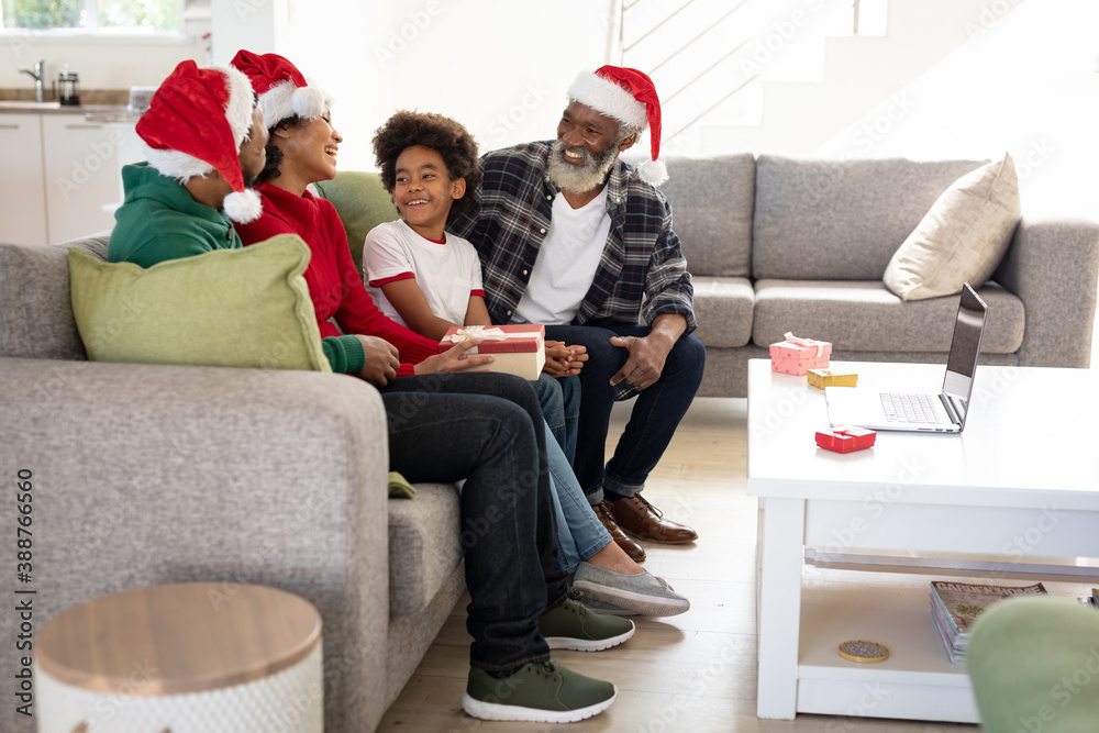 Fototapeta premium Multi-generation family having a video chat on laptop at home