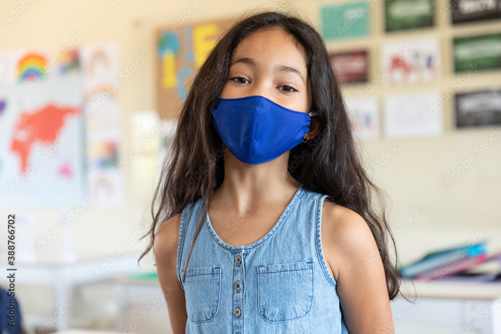 Portrait of girl wearing face mask at school