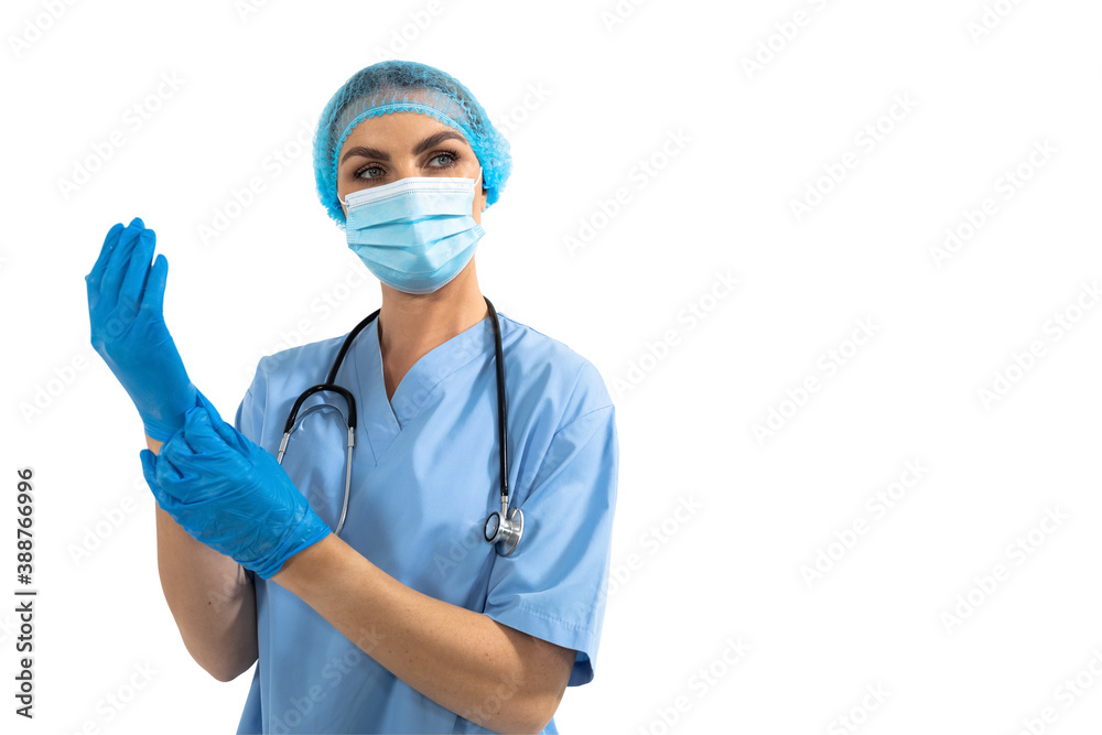Female surgeon wearing protective gloves against white background