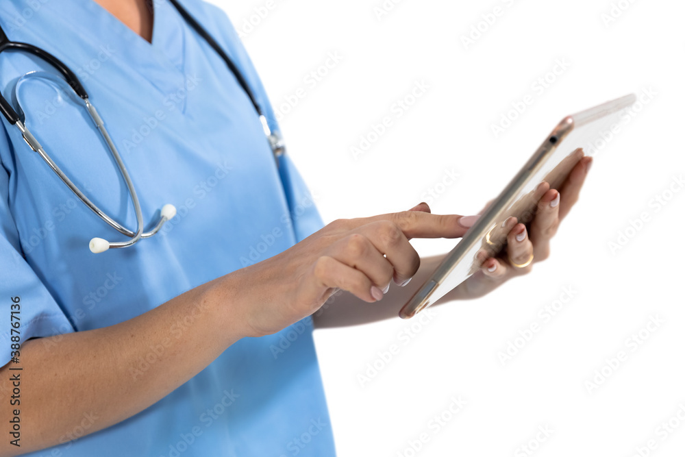 Mid section of female surgeon using digital tablet against white background Mid section of female surgeon using digital tablet against white background
