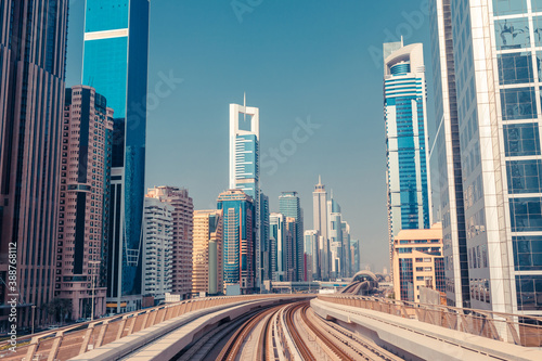 Downtown of Dubai with modern high skyscrapers. Architecture of future with metro monorail train
