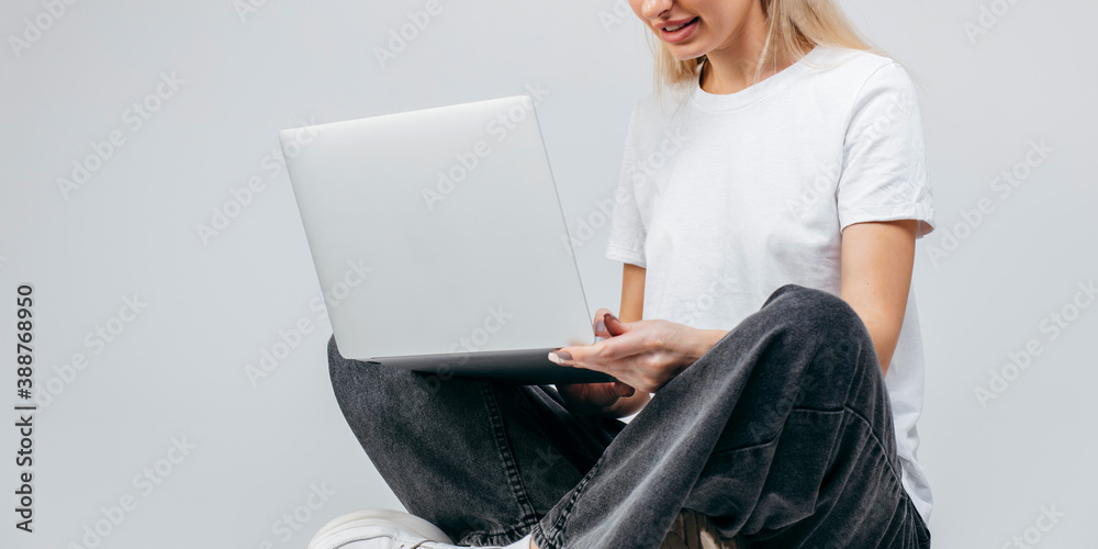 Modern Girl in white t-shirt with laptop in studio. Free creativity