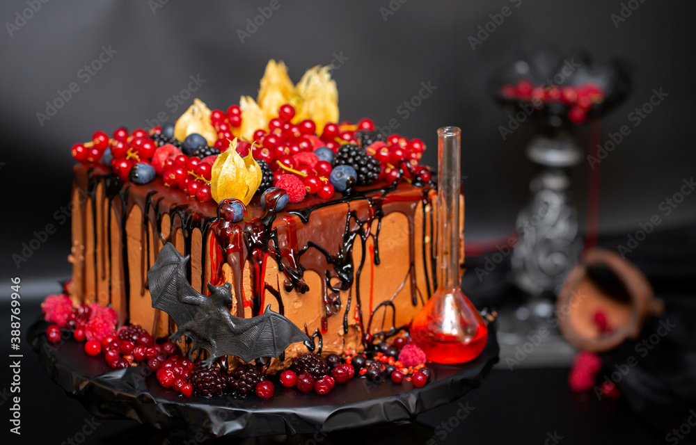 Cakes and pastries for Halloween celebration, holiday design with ghosts, bats and witchcraft potions on a black background. All saints' day confectionery.