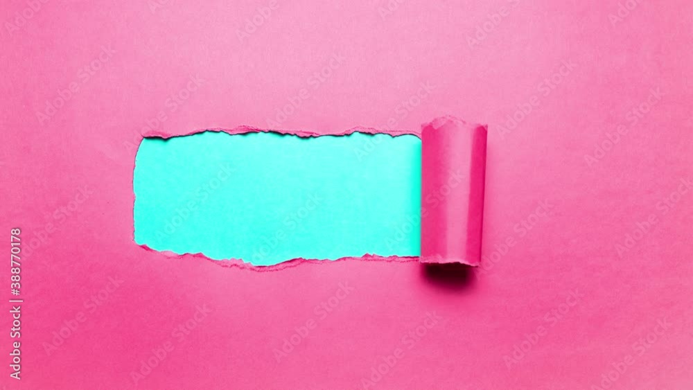 Stop motion photography concept. Diagonally torn pink paper with copy space for text of cyan or aqua menthe color.