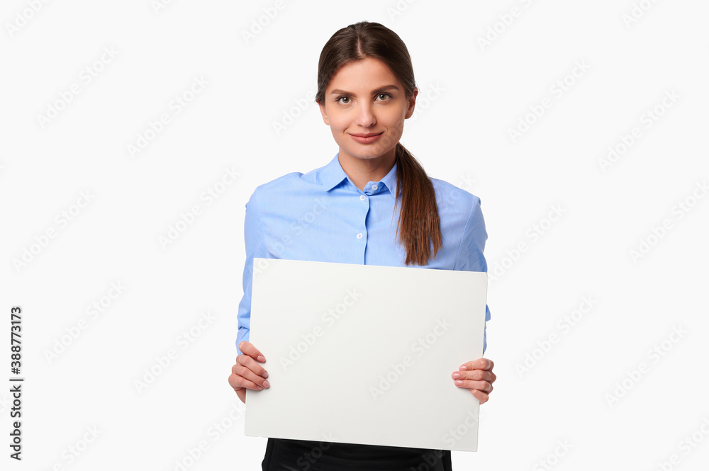 Attractive businesswoman in shirt holding white blank billboard and smiling on white isolated background Attractive businesswoman in shirt holding white blank billboard and smiling on white isolated background