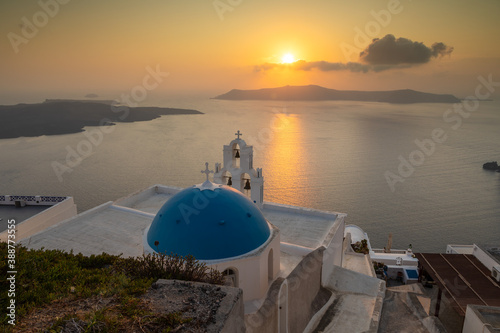 View of the sunset over the caldera, Catholic Church, Fira, Thira, Santorini, Greece.