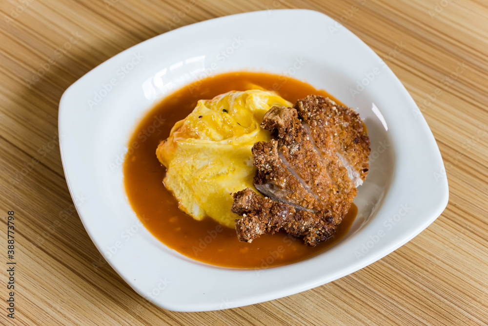 delicious fried pork chop in Japanese rice omelets also known as Omurice delicious fried pork chop in Japanese rice omelets also known as Omurice