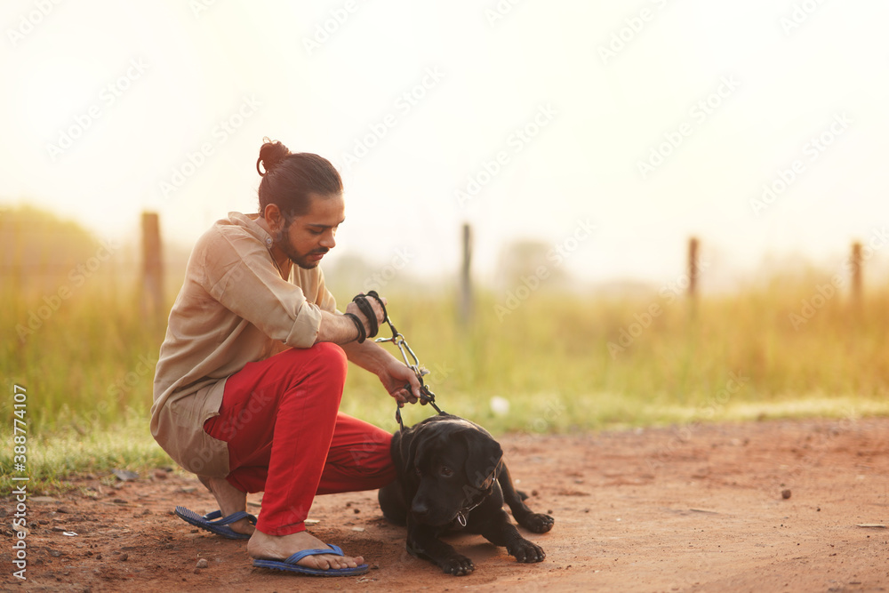 Young Man Seated with his Dog and telling Something | Training Black Labrador Dog 