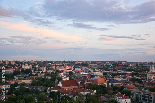 Vilnius panorama shot at sunset. Framing with greenery.