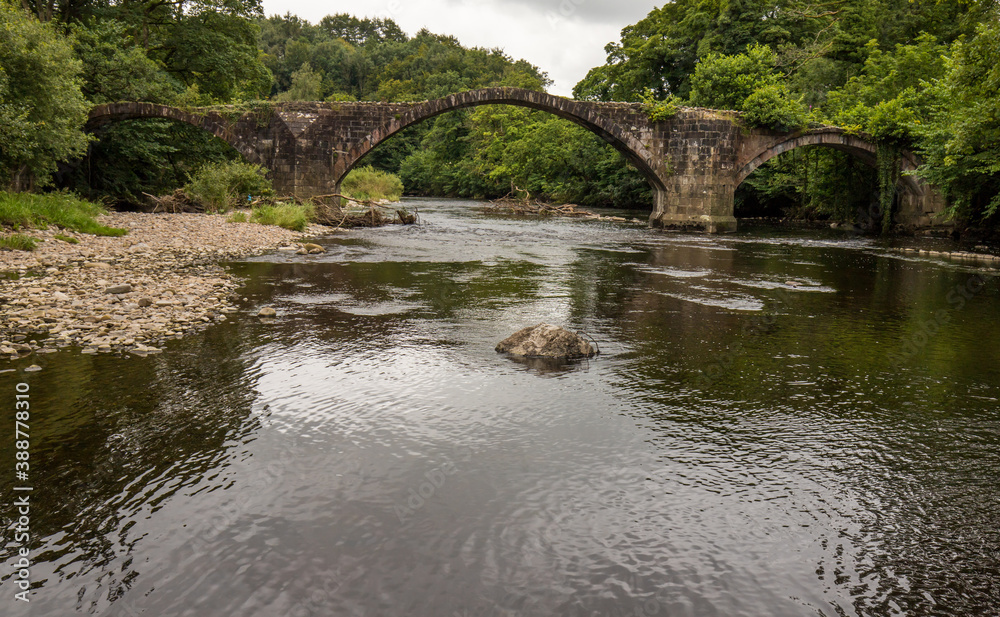 Fototapeta premium Cromwells bridge in the Ribble Valley, Lancashire. Old stone bridge over the river Hodder