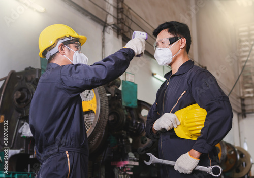 Checking temperature the worker inside the factory