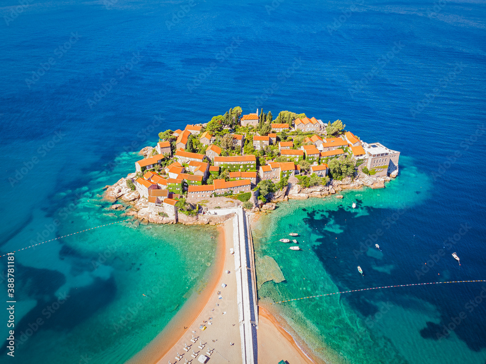 Famous Sveti Stefan island in Budva during a summer day, Montenegro. Drone aerial photo - obrazy, fototapety, plakaty 