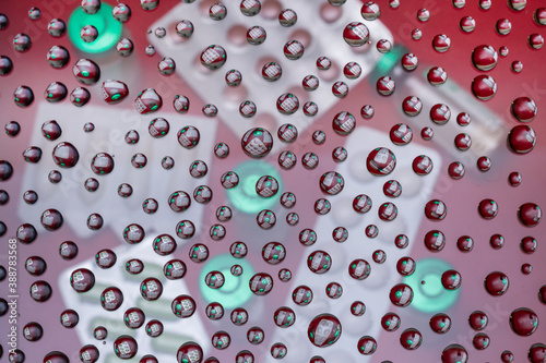 Background from drops of water on a glass.Reflection in drops of water of medicines.