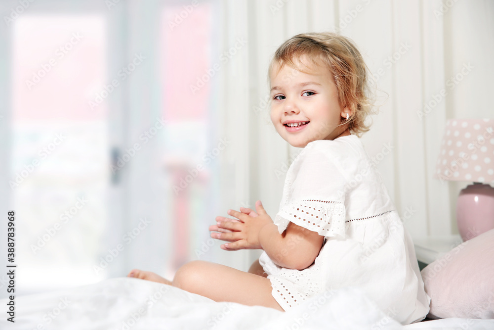 Little girl in bed,smiling kid good morning concept.happy child nursery design empty copy space. Little girl in bed,smiling kid good morning concept.happy child nursery design empty copy space.