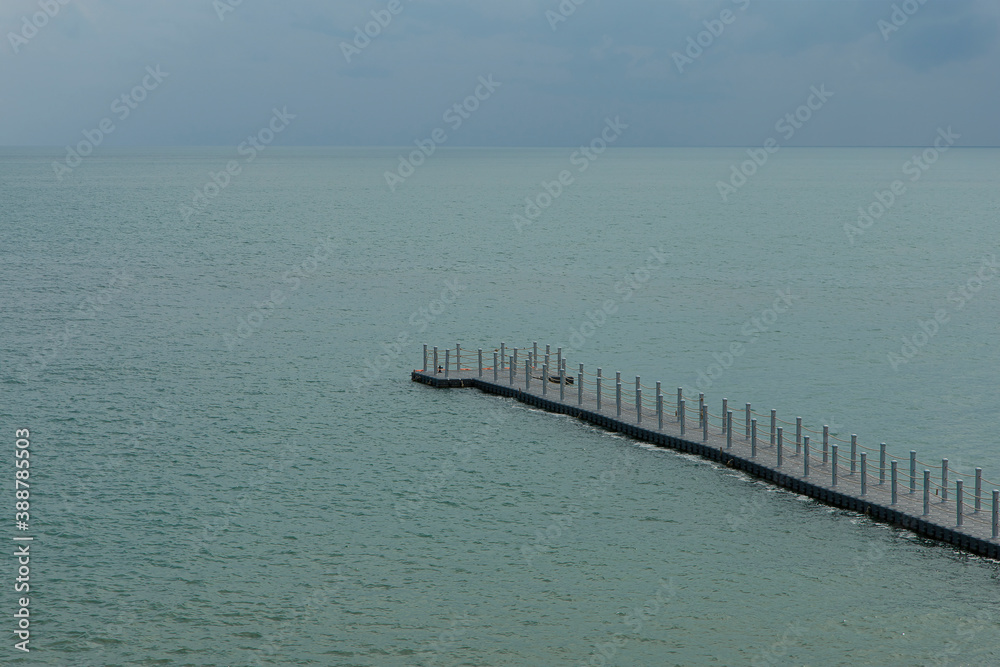 The buoy walkway extends into the sea.