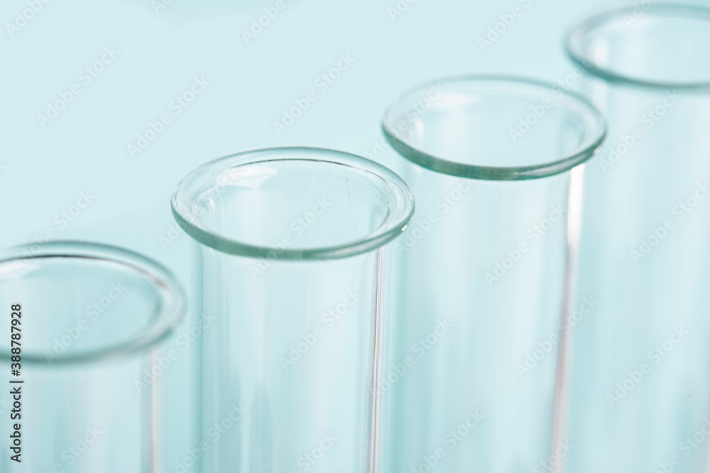 Macro laboratory glass test tubes over blue background Macro laboratory glass test tubes over blue background
