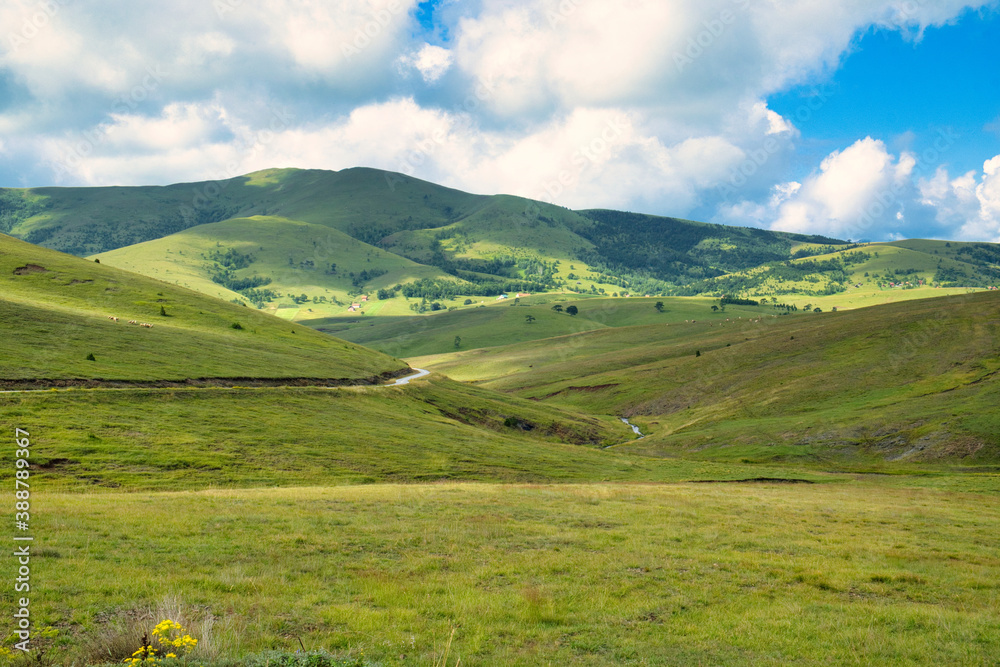 Amazing green field, pastures, mountain road and small farmer hut in the hills of Zlatibor resort in Western Serbia