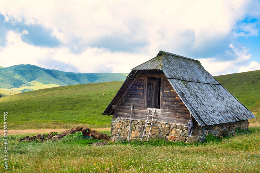 Amazing green field, pastures, mountain road and small farmer hut in the hills of Zlatibor resort in Western Serbia Amazing green field, pastures, mountain road and small farmer hut in the hills of Zlatibor resort in Western Serbia