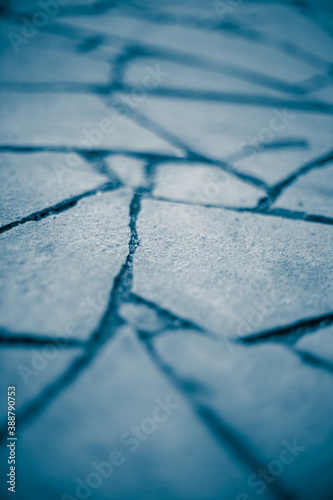 Wild stone pavement floor. Irregular shapes pattern. Deep blue tone.