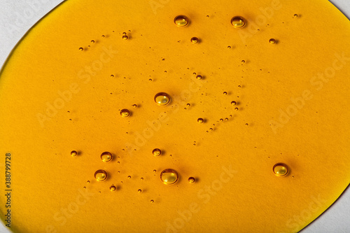 Photos Yellow viscous liquid lecithin with bubbles on glass