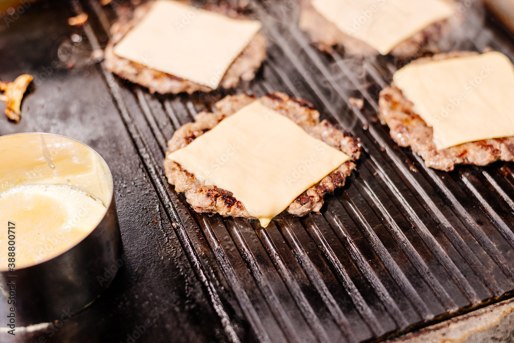 Burgers are grilled at the diner. Diner kitchen. Grill for burgers. Cheeseburgers are grilled. Burgers are grilled at the diner. Diner kitchen. Grill for burgers. Cheeseburgers are grilled.