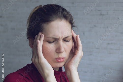 Young woman suffering from headache photo
