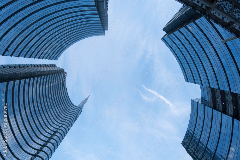 Fototapeta premium modern business buildings with crystals blue sky reflections curved circular skyscrapers top view