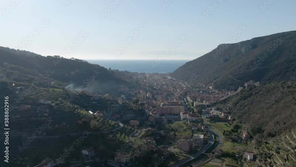 Backwards moving aerial shot of the valley of Finale in Italy on a sunny day. Backwards moving aerial shot of the valley of Finale in Italy on a sunny day.