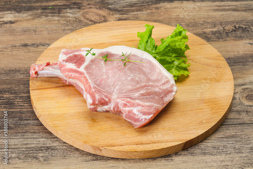 Raw pork bone steak over wooden