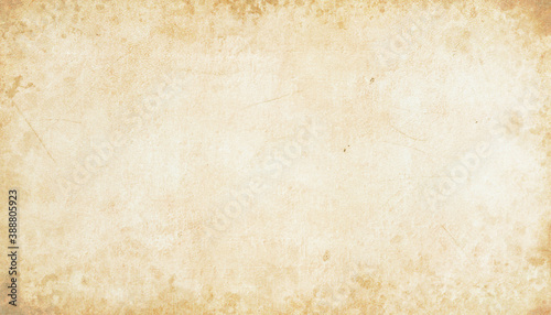 Old brown parchment background design with distressed vintage stains and ink spatter and white faded shabby center, elegant antique beige color photo