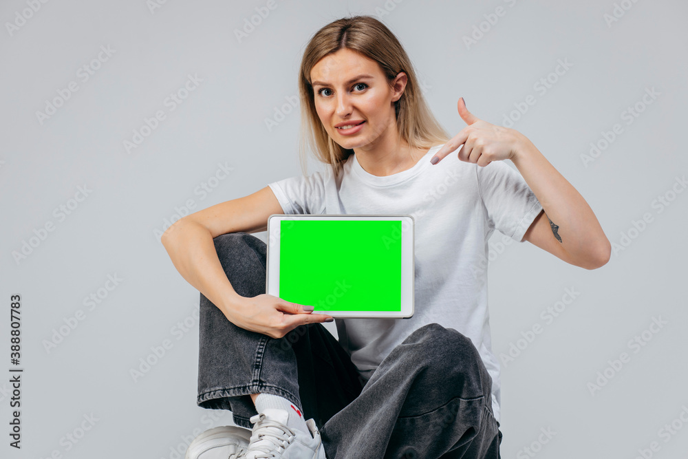 Modern Girl in white t-shirt with tablet in studio. Free creativity Modern Girl in white t-shirt with tablet in studio. Free creativity